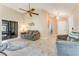 Inviting living room with neutral walls, ceiling fan, tile flooring, and sliding glass door at 704 Sky Tree Ct, New Smyrna Beach, FL 32168