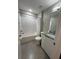 Bright bathroom featuring a shower-tub combo, modern vanity with granite countertop, and sleek design at 8008 Formosa Valley Pl, Kissimmee, FL 34747