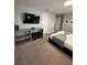 This bedroom features a TV and stylish desk area at 8008 Formosa Valley Pl, Kissimmee, FL 34747