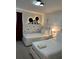 Whimsical bedroom with playful Mickey Mouse decor, featuring two comfortable twin beds at 8008 Formosa Valley Pl, Kissimmee, FL 34747