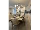 Open-concept dining area features seating for eight, stylish lighting, and seamless kitchen access at 8008 Formosa Valley Pl, Kissimmee, FL 34747