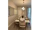 Stylish dining area features seating for eight, modern lighting, and elegant decor at 8008 Formosa Valley Pl, Kissimmee, FL 34747