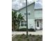 Two-story townhome showcases modern architecture, lush landscaping, and a welcoming front door at 8008 Formosa Valley Pl, Kissimmee, FL 34747