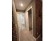 Hallway view showing bathroom and closet entrances, with brick-accented wall at 8008 Formosa Valley Pl, Kissimmee, FL 34747