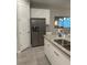 Modern kitchen featuring stainless steel appliances, granite countertops, and open layout flowing to dining area at 8008 Formosa Valley Pl, Kissimmee, FL 34747