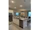 Modern kitchen featuring stainless steel appliances, granite countertops, and a seamless flow to the dining area at 8008 Formosa Valley Pl, Kissimmee, FL 34747