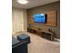 Cozy room with modern media center, large screen TV, comfortable seating, and plush carpet at 8008 Formosa Valley Pl, Kissimmee, FL 34747