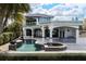 An expansive backyard with an outdoor kitchen and a sparkling pool overlooking the lake at 801 W 2Nd Ave, Windermere, FL 34786