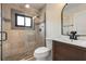 Stylish bathroom featuring a glass-enclosed shower, vanity with dark wood cabinets, and neutral colored tiles at 801 W 2Nd Ave, Windermere, FL 34786