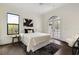 Bright bedroom featuring hardwood floors, a modern bed, and access to a balcony through arched French doors at 801 W 2Nd Ave, Windermere, FL 34786