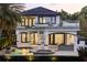 Exterior view of the home from the backyard showcasing the patio, upper balcony, and custom pool at 801 W 2Nd Ave, Windermere, FL 34786