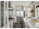 Modern kitchen featuring stainless steel appliances, including a large refrigerator, and sleek white cabinetry at 801 W 2Nd Ave, Windermere, FL 34786