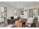 Open-concept living space has hardwood flooring, neutral color palette, a wet bar, and many windows offering natural light at 801 W 2Nd Ave, Windermere, FL 34786