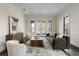 Bright living room features neutral decor, hardwood floors, stylish furnishings, and French doors to the exterior at 801 W 2Nd Ave, Windermere, FL 34786