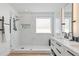 Beautifully designed bathroom showcasing a glass enclosed shower, marble wall tiles, and modern vanity at 8010 Soldierwood St, Winter Garden, FL 34787