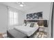 Stylish bedroom featuring a comfortable bed with decor, a cushioned bench, and sheer curtains for natural light at 8010 Soldierwood St, Winter Garden, FL 34787