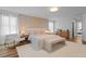 Elegant bedroom with a queen bed, a white accent chair, warm lighting, and a fluffy carpet for a luxurious feel at 8010 Soldierwood St, Winter Garden, FL 34787
