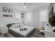 Bright bedroom featuring a queen size bed with soccer ball decor and plush pillows, plus sheer white curtains at 8010 Soldierwood St, Winter Garden, FL 34787