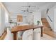 Bright dining room featuring a wood table, modern chandelier, white chairs, and beautiful decor at 8010 Soldierwood St, Winter Garden, FL 34787