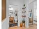 Hallway view of half bath and bedroom, with light wood floors and modern decor at 8010 Soldierwood St, Winter Garden, FL 34787