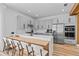 Contemporary kitchen with a breakfast bar, gray cabinets, stainless steel appliances, and modern fixtures at 8010 Soldierwood St, Winter Garden, FL 34787