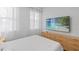 Inviting main bedroom featuring neutral tones, soft lighting, plush bedding, and bright, sheer curtains at 8010 Soldierwood St, Winter Garden, FL 34787