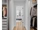Bright walk-in closet leading to a modern bathroom featuring sleek, contemporary design and luxurious finishes at 8010 Soldierwood St, Winter Garden, FL 34787