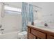 Bathroom featuring a tub with shower, a vanity, and a toilet at 8073 Santee Dr, Kissimmee, FL 34747