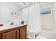 Bathroom with a tub and shower combo, vanity, toilet, and themed wall decor at 8073 Santee Dr, Kissimmee, FL 34747