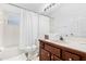 Bathroom with a bathtub and shower, a vanity, and a toilet with a blue-striped label at 8073 Santee Dr, Kissimmee, FL 34747