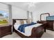 Well-lit bedroom with a dark wood furniture set and a ceiling fan at 8073 Santee Dr, Kissimmee, FL 34747