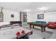Spacious game room with air hockey, foosball, and pool tables, plus seating area at 8073 Santee Dr, Kissimmee, FL 34747