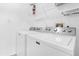 Laundry room showcasing a modern Maytag washer and dryer set with shelving at 8073 Santee Dr, Kissimmee, FL 34747