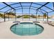 Unique Mickey Mouse-shaped pool is screened-in and features an attached hot tub at 8073 Santee Dr, Kissimmee, FL 34747