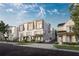 View of new townhomes on brick-paved street, showcasing modern architecture and landscaping at 1002 E Robinson St # 1, Orlando, FL 32801