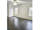 Bedroom featuring hardwood floors, light walls, and natural light from the windows at 10071 Cypress Knee Cir, Orlando, FL 32825