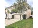 Two-car garage complements the home's fresh exterior, surrounded by a well-maintained lawn and landscaping at 10071 Cypress Knee Cir, Orlando, FL 32825