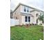 Two-story home exhibiting manicured front lawn with fresh mulch beds and vibrant greenery at 10071 Cypress Knee Cir, Orlando, FL 32825