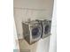 Laundry room equipped with a washer and dryer and wire rack shelving at 10071 Cypress Knee Cir, Orlando, FL 32825