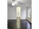 Bright living room displaying hardwood floors, light walls and view of hallway at 10071 Cypress Knee Cir, Orlando, FL 32825