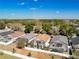 Community aerial shot showcasing fenced in backyards, lush trees, and well-maintained landscaping at 1049 Winding Water Way, Clermont, FL 34714