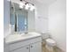 Bright bathroom featuring neutral walls, a single sink and vanity, and tiled flooring at 1049 Winding Water Way, Clermont, FL 34714