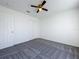 Bedroom with soft gray carpet, a ceiling fan, and a closet, creating a calm and inviting atmosphere at 1049 Winding Water Way, Clermont, FL 34714