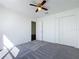 Bedroom with soft gray carpet, a ceiling fan, and a closet, creating a calm and inviting atmosphere at 1049 Winding Water Way, Clermont, FL 34714