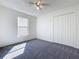 Bedroom with soft gray carpet, a ceiling fan, and a closet, creating a calm and inviting atmosphere at 1049 Winding Water Way, Clermont, FL 34714