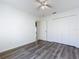 Bedroom featuring neutral walls, laminate flooring, a ceiling fan and double door closet at 1049 Winding Water Way, Clermont, FL 34714