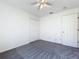 Bedroom with soft gray carpet, a ceiling fan, and a closet, creating a calm and inviting atmosphere at 1049 Winding Water Way, Clermont, FL 34714