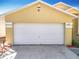 Single-Gathering home featuring a two-car garage and a well-maintained front yard at 1049 Winding Water Way, Clermont, FL 34714