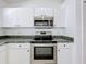 A kitchen featuring stainless steel appliances and ample white cabinetry at 1049 Winding Water Way, Clermont, FL 34714