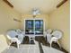 Enclosed patio featuring tiled floors, a ceiling fan, and furniture to enjoy the outdoors at 1049 Winding Water Way, Clermont, FL 34714